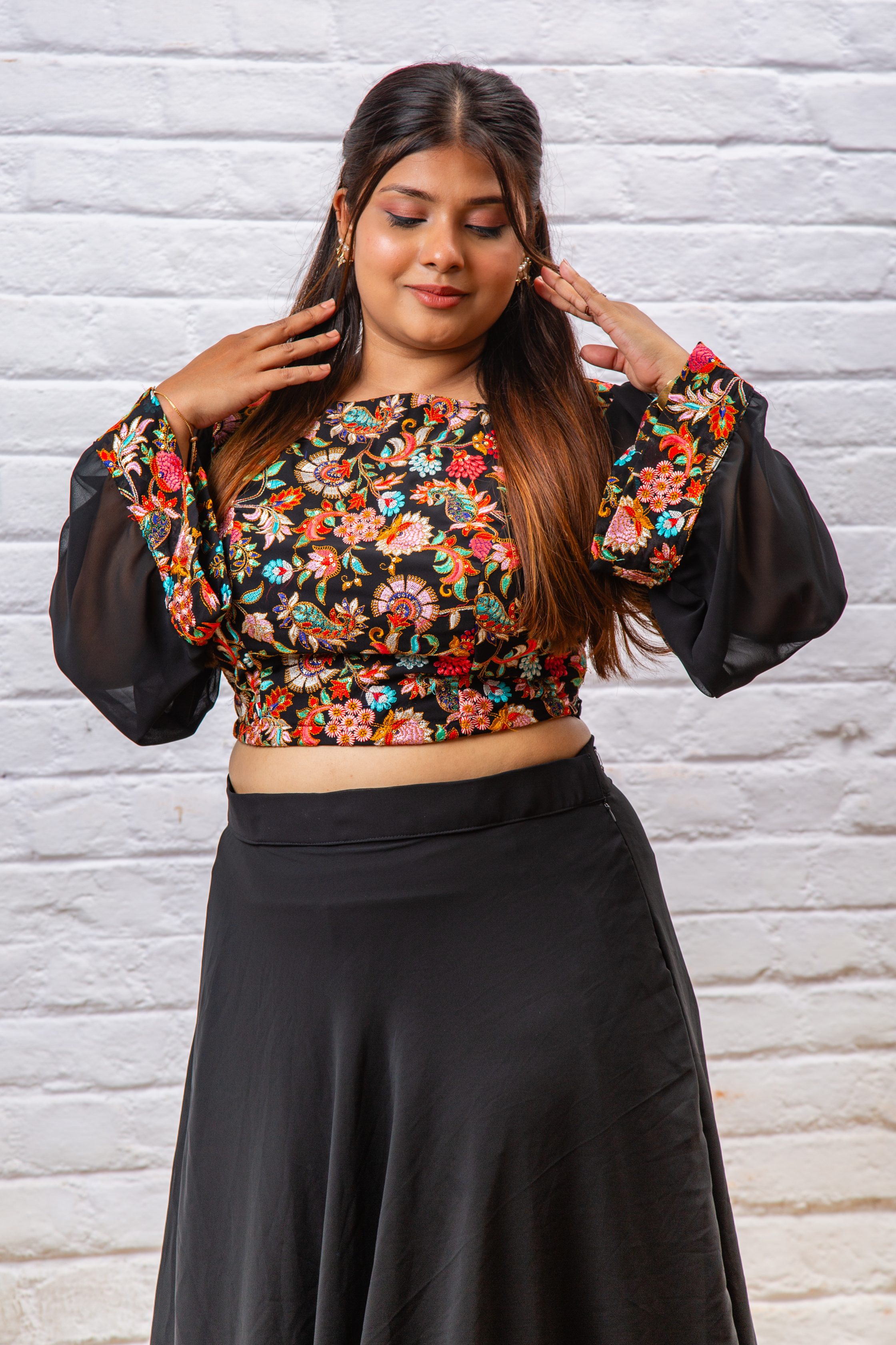Woman wearing a black floral embroidered Indo-Western dress
