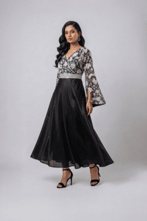 Woman wearing a black gown with a monochrome printed wrap bodice, flared kimono sleeves and a flowing maxi skirt