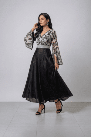 Woman wearing a black gown with a monochrome printed wrap bodice, flared kimono sleeves and a flowing maxi skirt