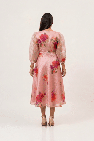 Woman wearing a Blossom Breeze Party Wear midi dress with three-quarter puff sleeves and an A-line silhouette