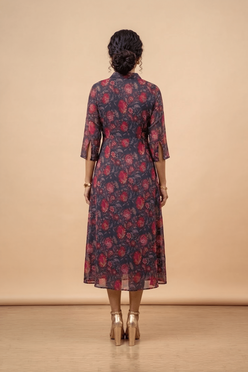 Woman wearing a blue floral shirt dress with three-quarter sleeves and a flared midi silhouette