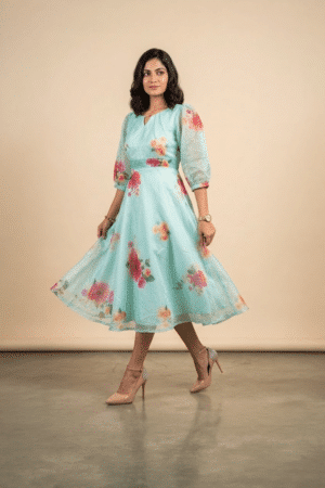 Woman wearing a Blossom Breeze Party Wear midi dress with puff sleeves and an A-line silhouette