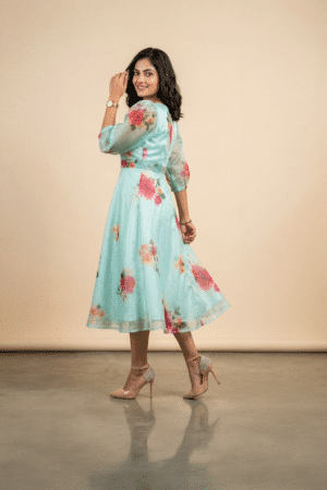 Woman wearing a Blossom Breeze Party Wear midi dress with puff sleeves and an A-line silhouette