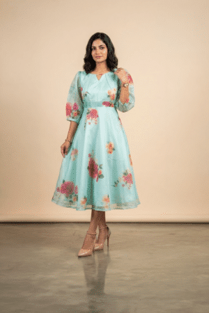 Woman wearing a Blossom Breeze Party Wear midi dress with puff sleeves and an A-line silhouette