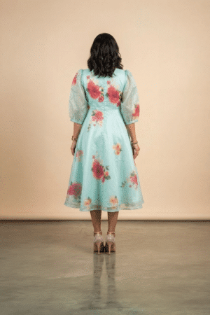 Woman wearing a Blossom Breeze Party Wear midi dress with puff sleeves and an A-line silhouette