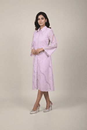 Woman wearing a lavender shirt-style midi dress with embroidered cutwork, button-down front and flared three-quarter sleeves