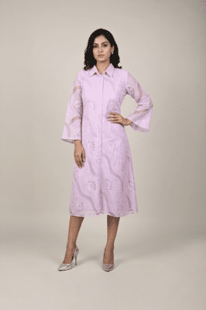 Woman wearing a lavender shirt-style midi dress with embroidered cutwork, button-down front and flared three-quarter sleeves