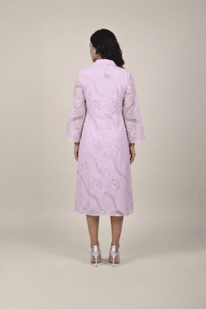 Woman wearing a lavender shirt-style midi dress with embroidered cutwork, button-down front and flared three-quarter sleeves
