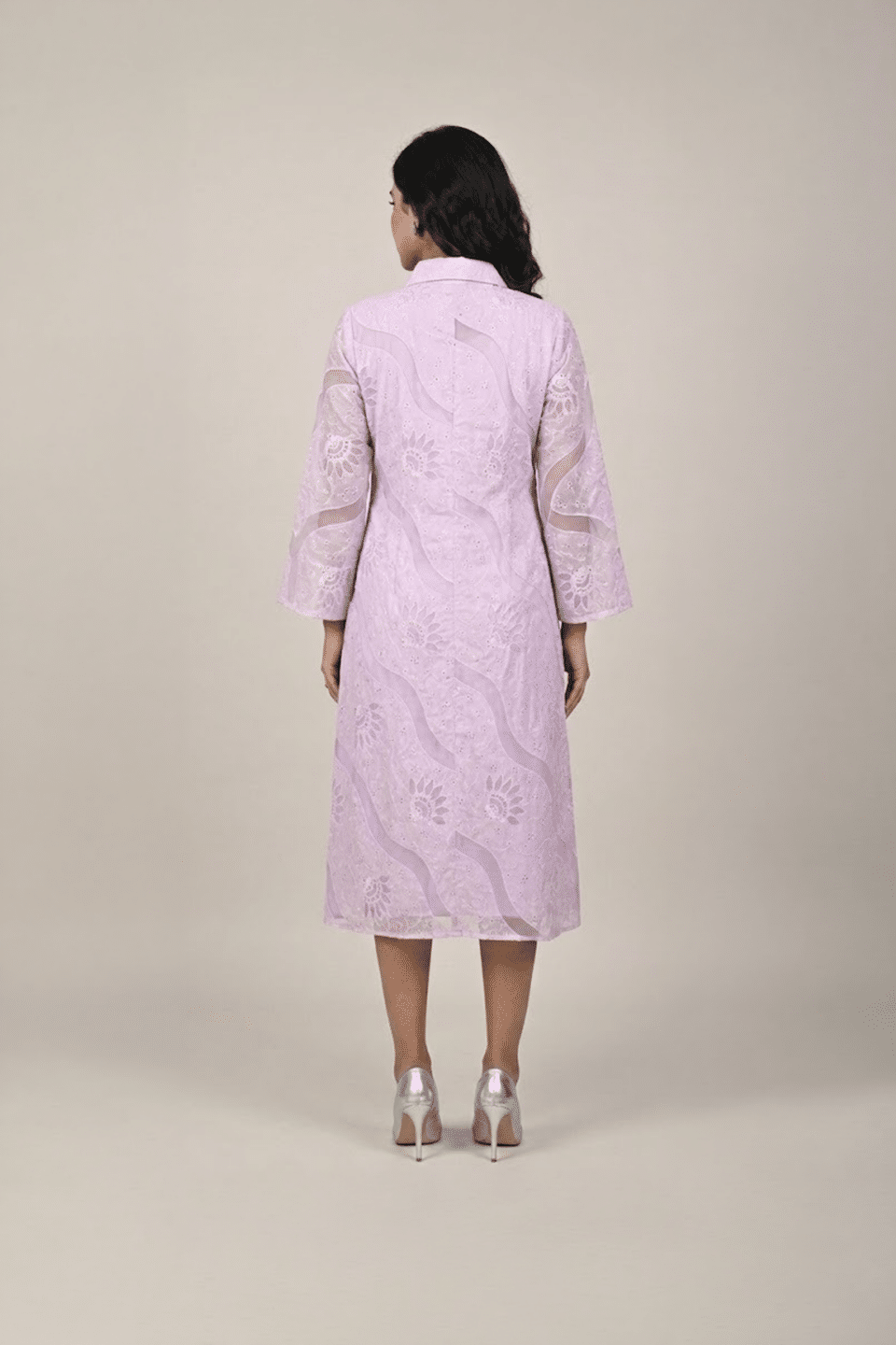Woman wearing a lavender shirt-style midi dress with embroidered cutwork, button-down front and flared three-quarter sleeves