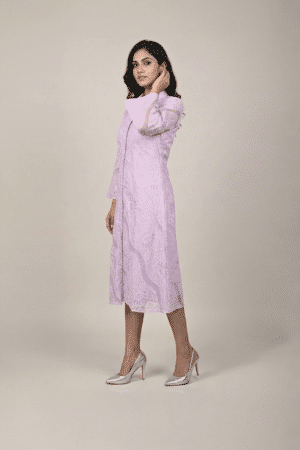 Woman wearing a lavender shirt-style midi dress with embroidered cutwork, button-down front and flared three-quarter sleeves