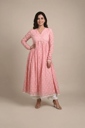 Woman wearing a dusty pink embroidered Anarkali with a scalloped V-neckline, long sleeves and white pants