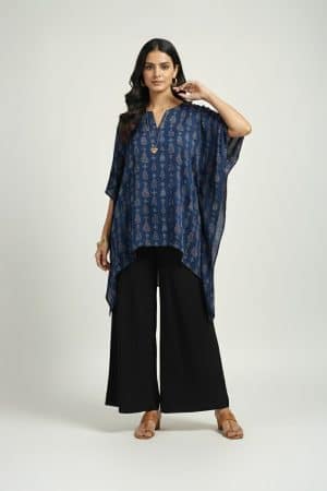 Woman wearing blue printed kaftan top with black wide-leg pants