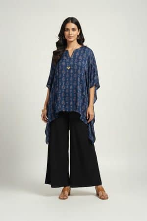Woman wearing blue printed kaftan top with black wide-leg pants