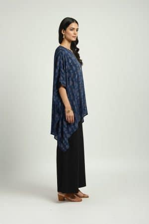 Woman wearing blue printed kaftan top with black wide-leg pants