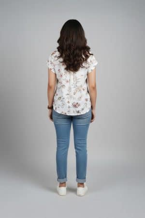 Cream floral shirt top for women with short sleeves and relaxed fit paired with blue jeans