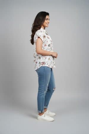 Cream floral shirt top for women with short sleeves and relaxed fit paired with blue jeans