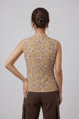 Mustard Floral Sleeveless Top with button-down front and brown trousers